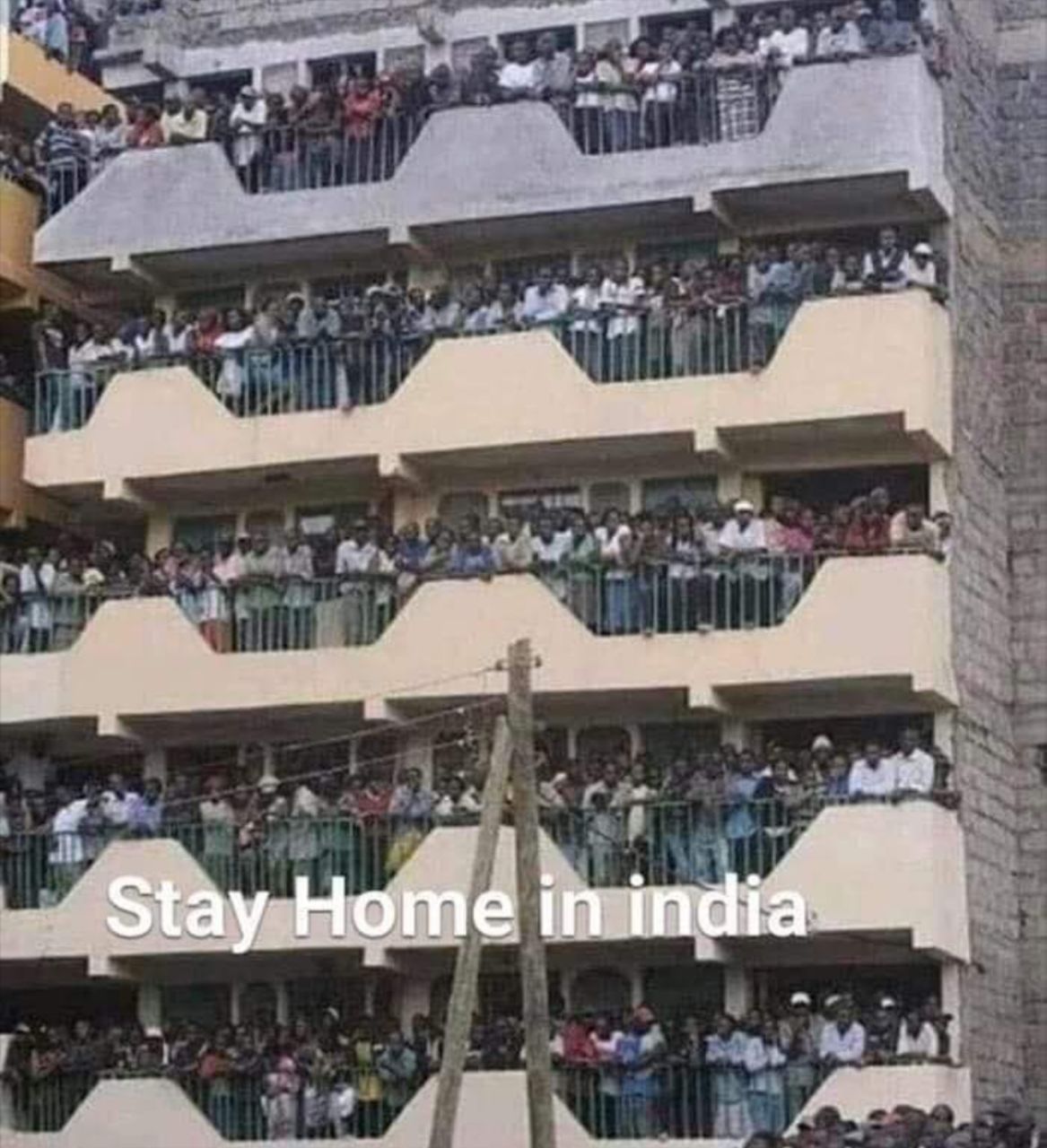 a large crowd of people standing on the balcony of a building